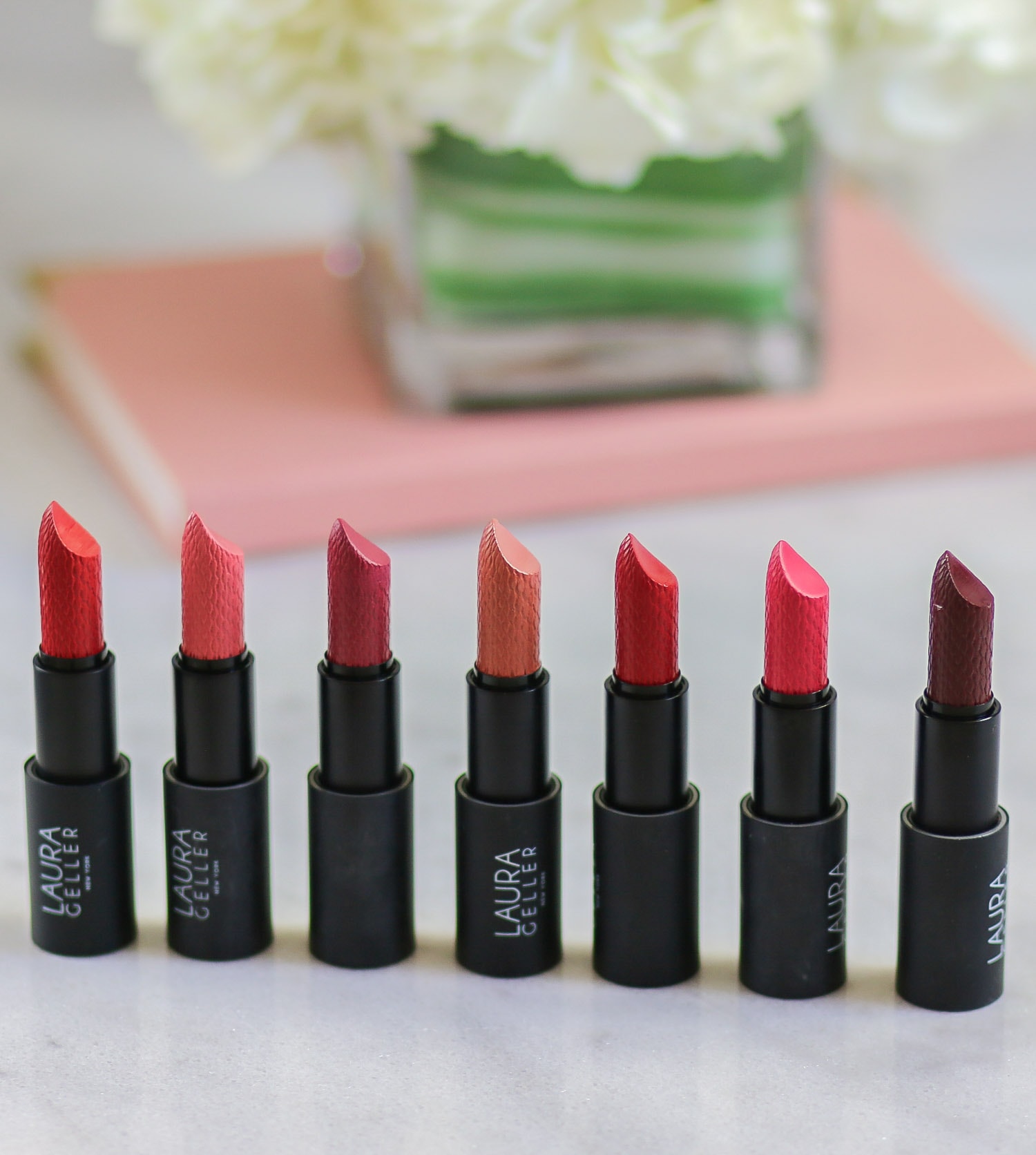 The Laura Geller Iconic Baked Sculpting Lipsticks are absolutely wonderful. They're highly pigmented and smooth lipsticks with a satin finish. The formula is long-lasting, but your lips feel comfortable all day long. This line is available in 12 shades. Click through to see lip swatches of this line from beauty blogger Ashley Brooke Nicholas! @laurageller