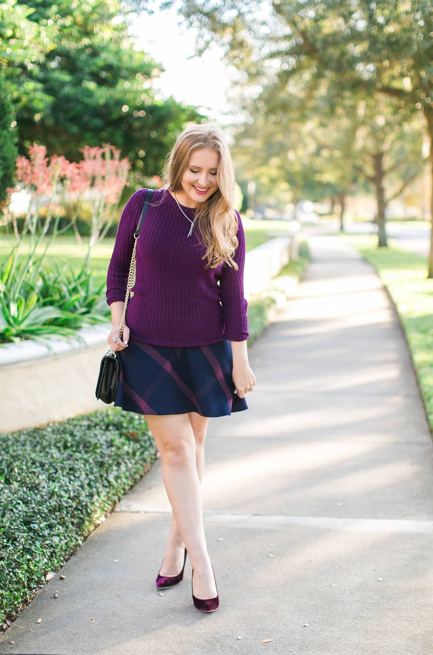 Burgundy sweater, navy and pink plaid skirt, Rebecca Minkoff black quilted handbag, Sam Edelman burgundy velvet pumps, and Phillip Gavriel jewelry styled in a preppy outfit idea by Florida fashion and personal style blogger Ashley Brooke Nicholas | preppy style, preppy fashion, affordable outfit ideas, cute outfits, cute outfit idea